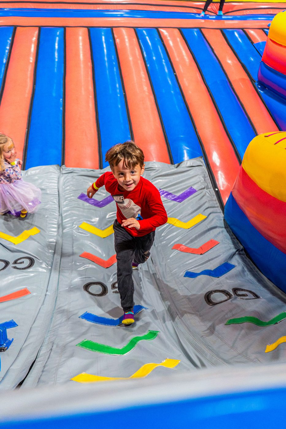 Boy racing down the 23-foot slide at FUNBOX Houston