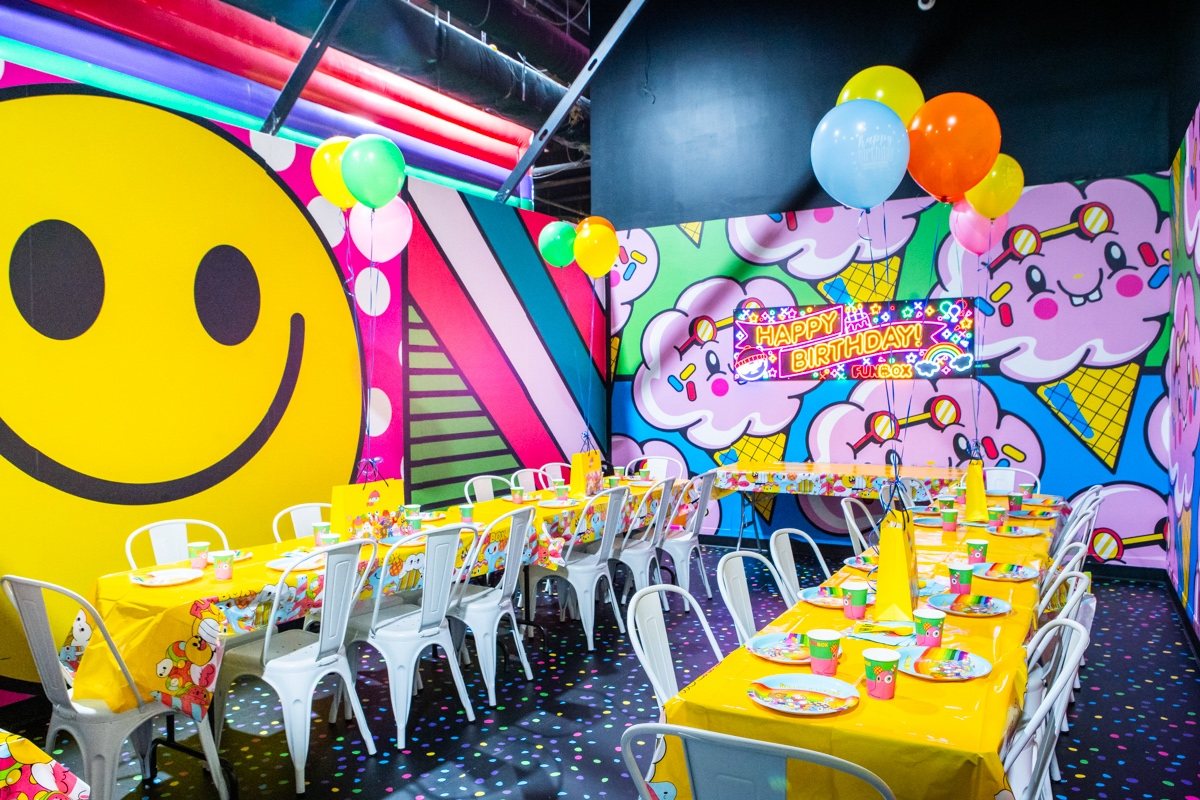 FUNBOX Houston private party room set with yellow tables, balloons and decor
