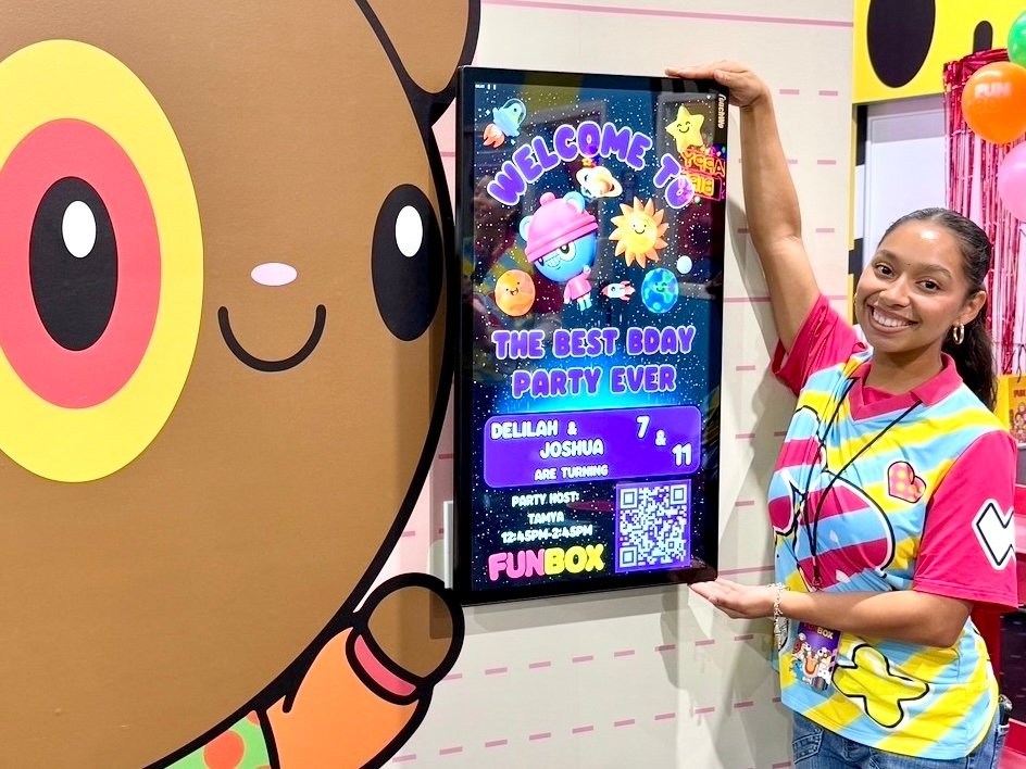FUNBOX party host smiling next to the personalized birthday welcome screen